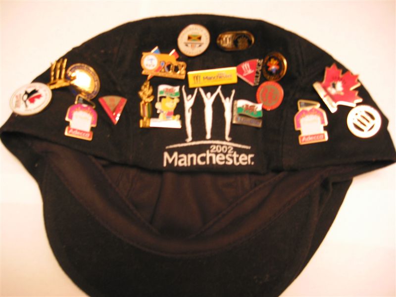 My flat cap complete with pin collection